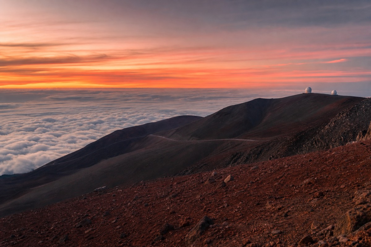 The summit ridge of Maunakea above the clouds near sunset