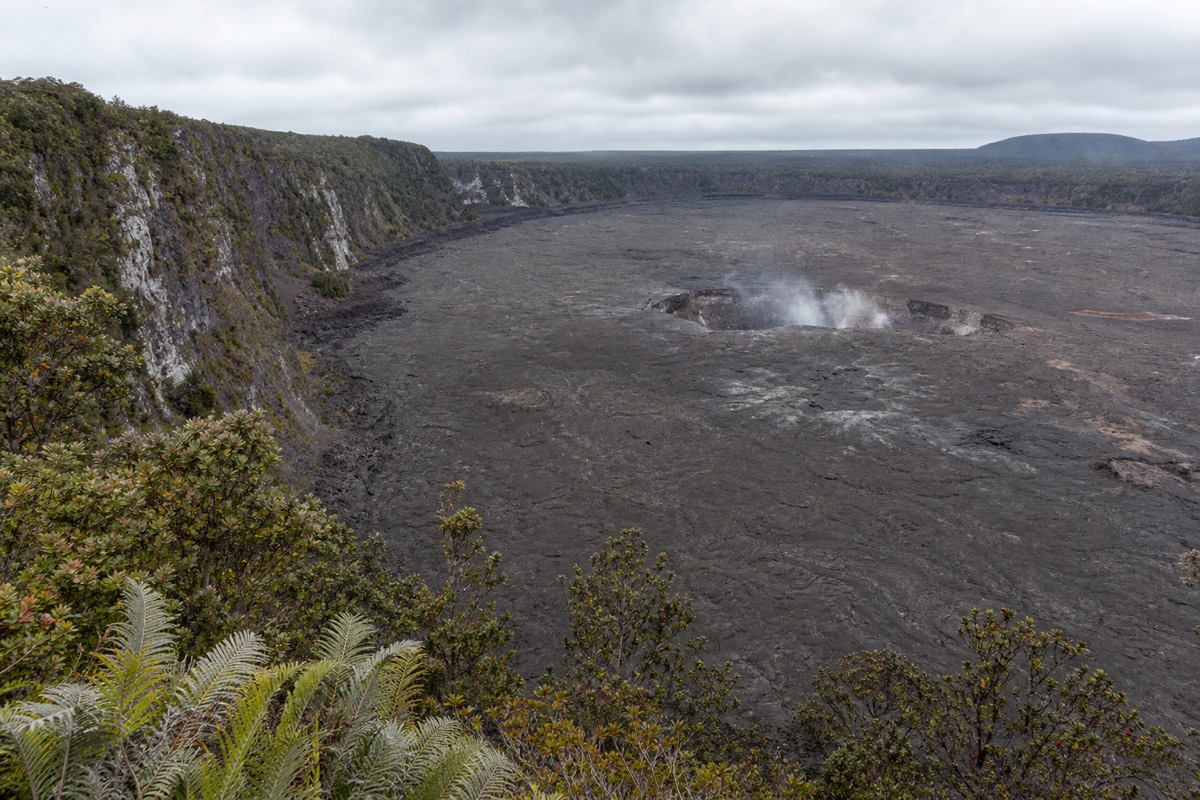 The wide floor of Kīlauea caldera seen from an overlook on the crater rim