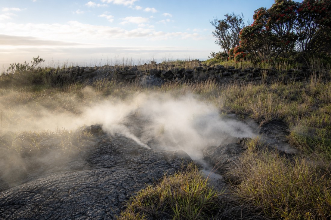 Steam rising from ground cracks along the Kīlauea summit rim