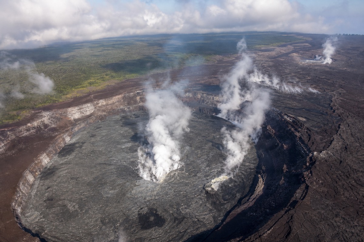 Aerial view of the steaming Kīlauea caldera from a helicopter over Hawaii Volcanoes National Park