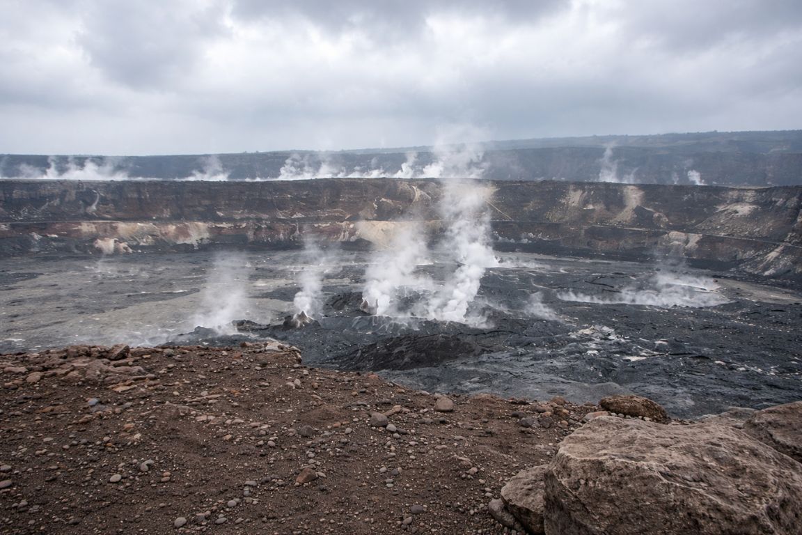 Halemaʻumaʻu Crater volcanic basin with steaming vents under cloudy sky in Hilo Hawaii, photographed during a Hilo Tours guided experience