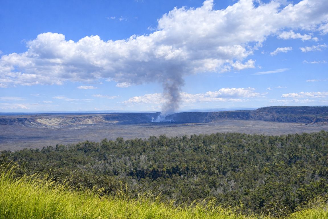 Panoramic view of Hawaii Volcanoes National Park featuring smoking crater and tropical greenery, seen during a guided tour with Hilo Tours