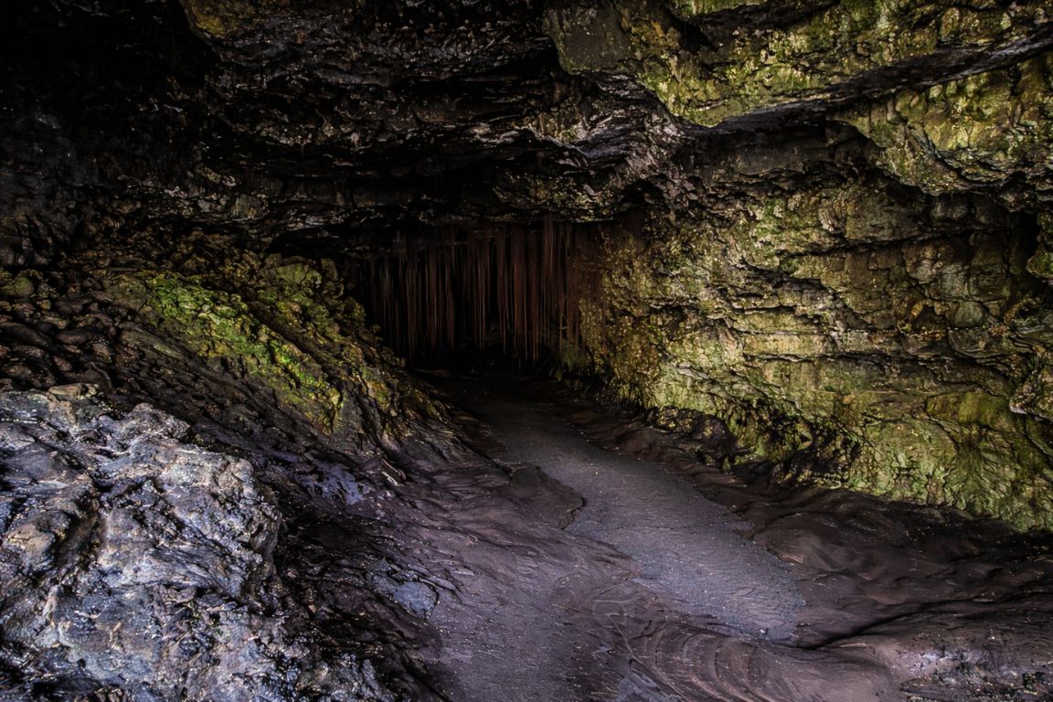 Kaumana Caves lava tube in Hilo Hawaii showcasing raw volcanic landscape and cave textures, photographed during a tour with Hilo Tours